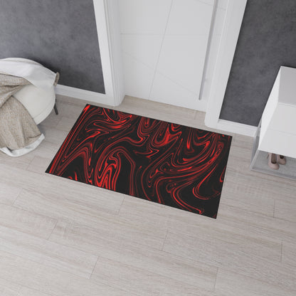 Decorative doormat with red and white abstract pattern on a wooden floor.