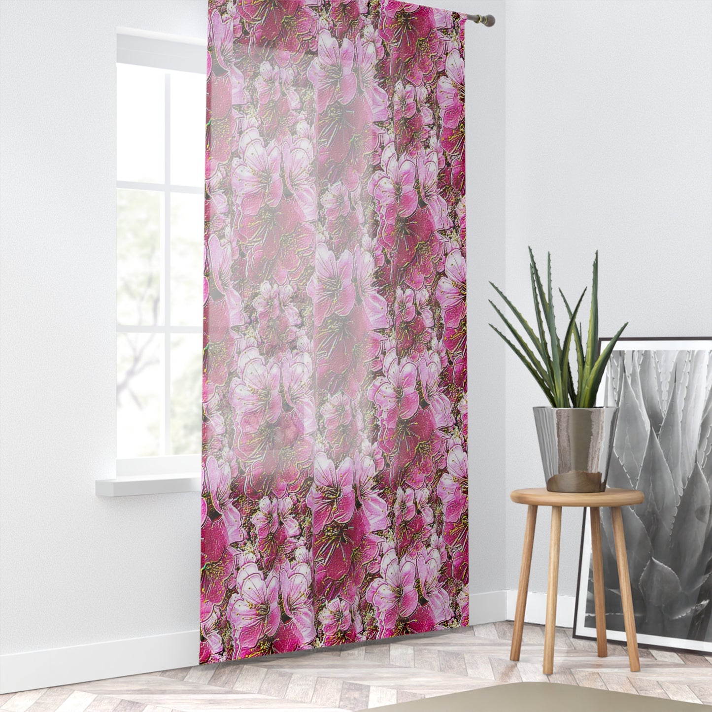Bright, airy room with pink floral sheer curtains over a window, styled with a potted plant and a herringbone floor.