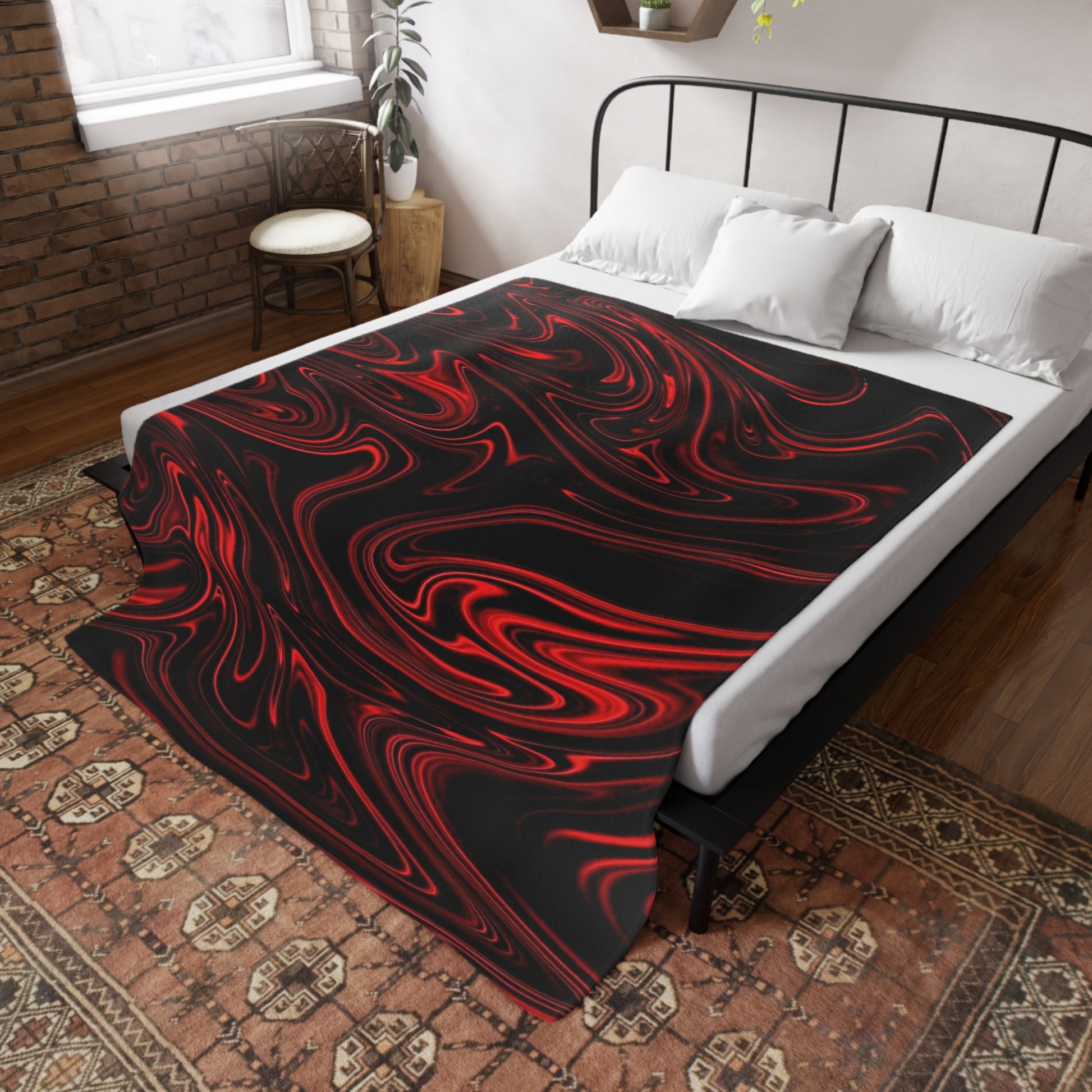 A black bed throw with a red liquid marble pattern draped over a white-sheeted bed in a rustic, brick-walled bedroom.