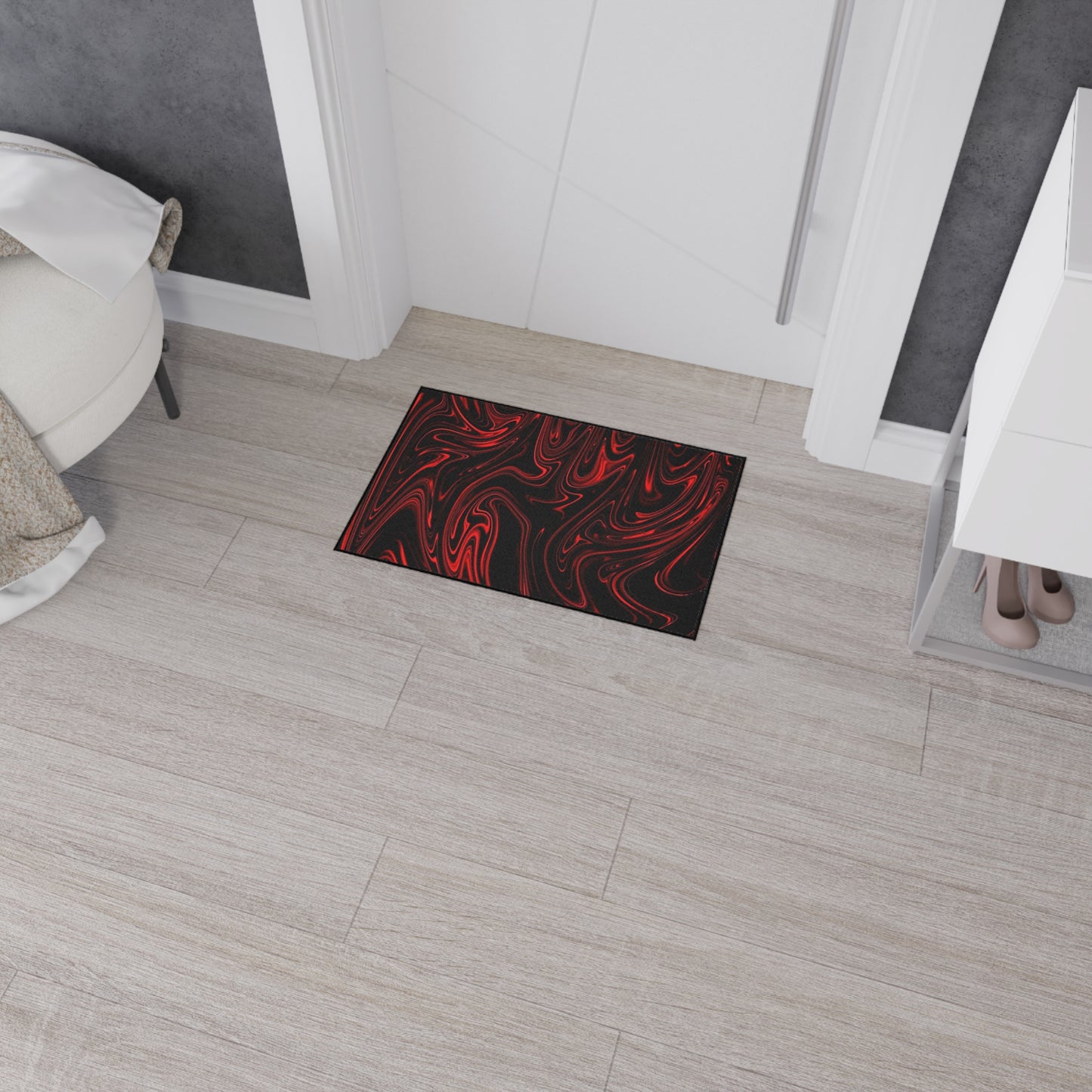 Black doormat with red text on a wooden floor in a room setting
