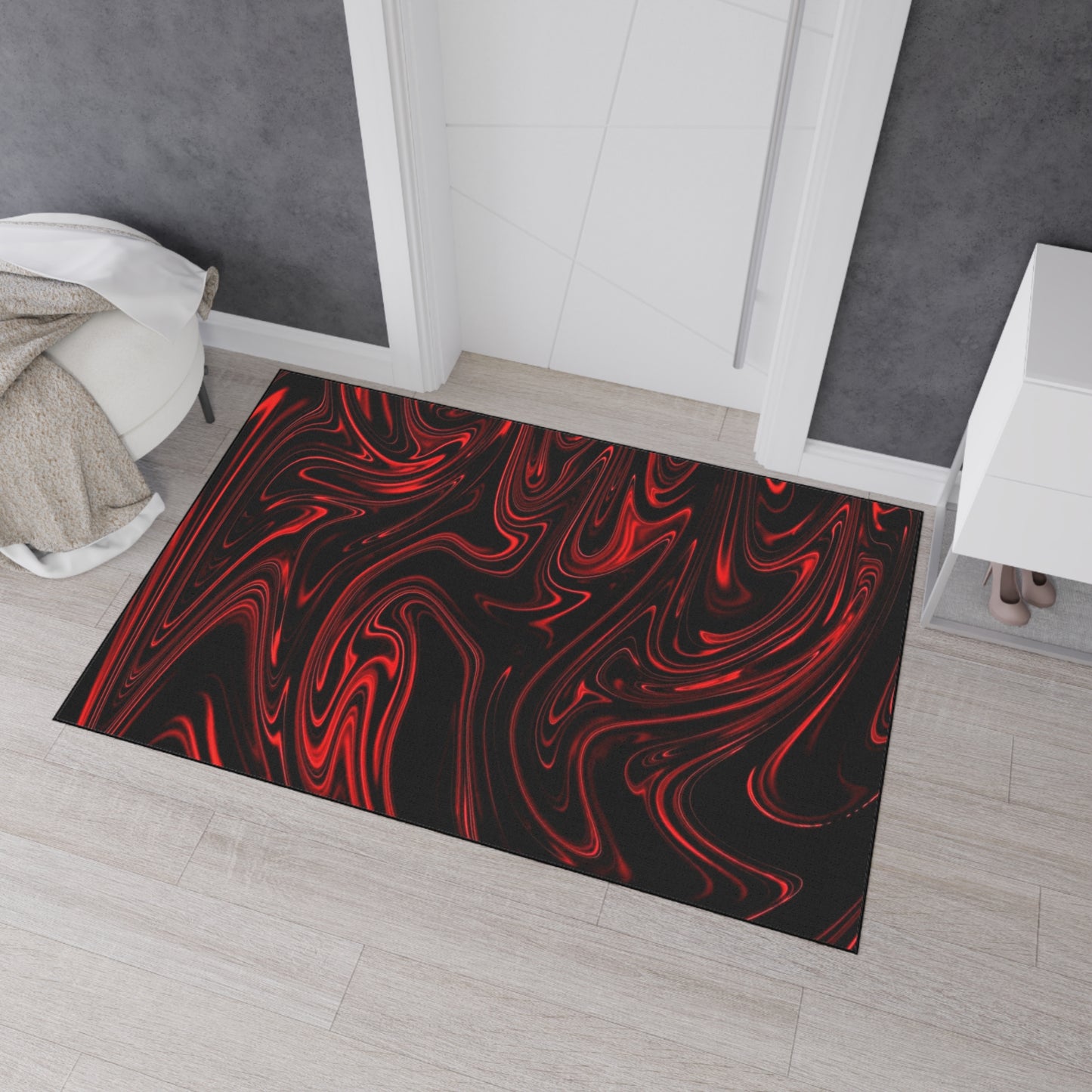 Decorative doormat with red and black abstract pattern on a wooden floor.