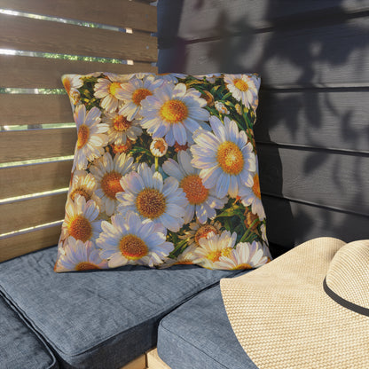 The Dawning Field medium square floral throw pillow placed on outdoor slatted patio seating with blue cushions and a sun hat.