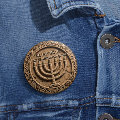 Medium-sized round pinback button with a carved seven-branch menorah medallion design pinned to a blue denim jean jacket.