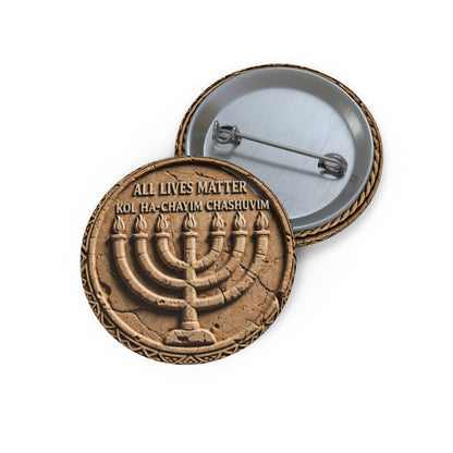 Small round pinback button with an engraved stone menorah artwork displayed alongside its open silver metal pinback fastener.