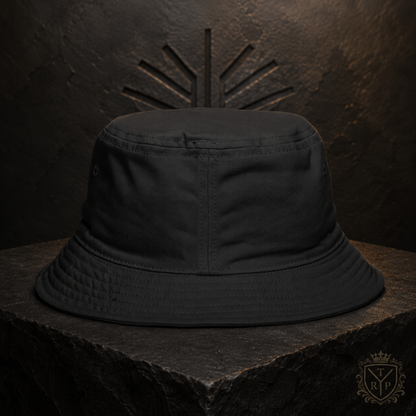 Back view of the black All Lives Matter bucket hat displayed on a stone pedestal against a carved background.