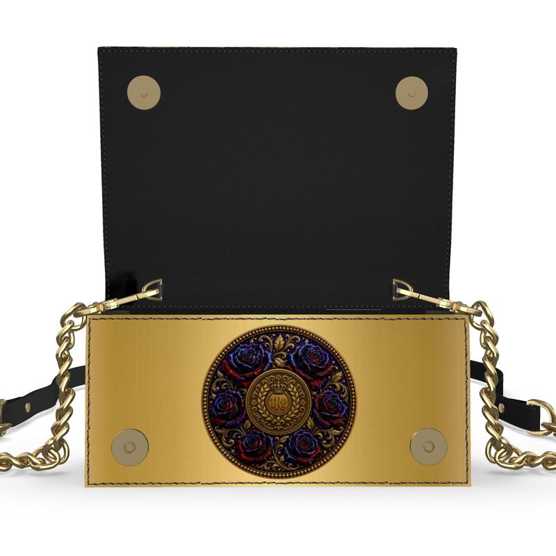 The foldover evening bag opened up, revealing a smooth black interior flap, magnetic closures, and a gold inner face with a central rose emblem.