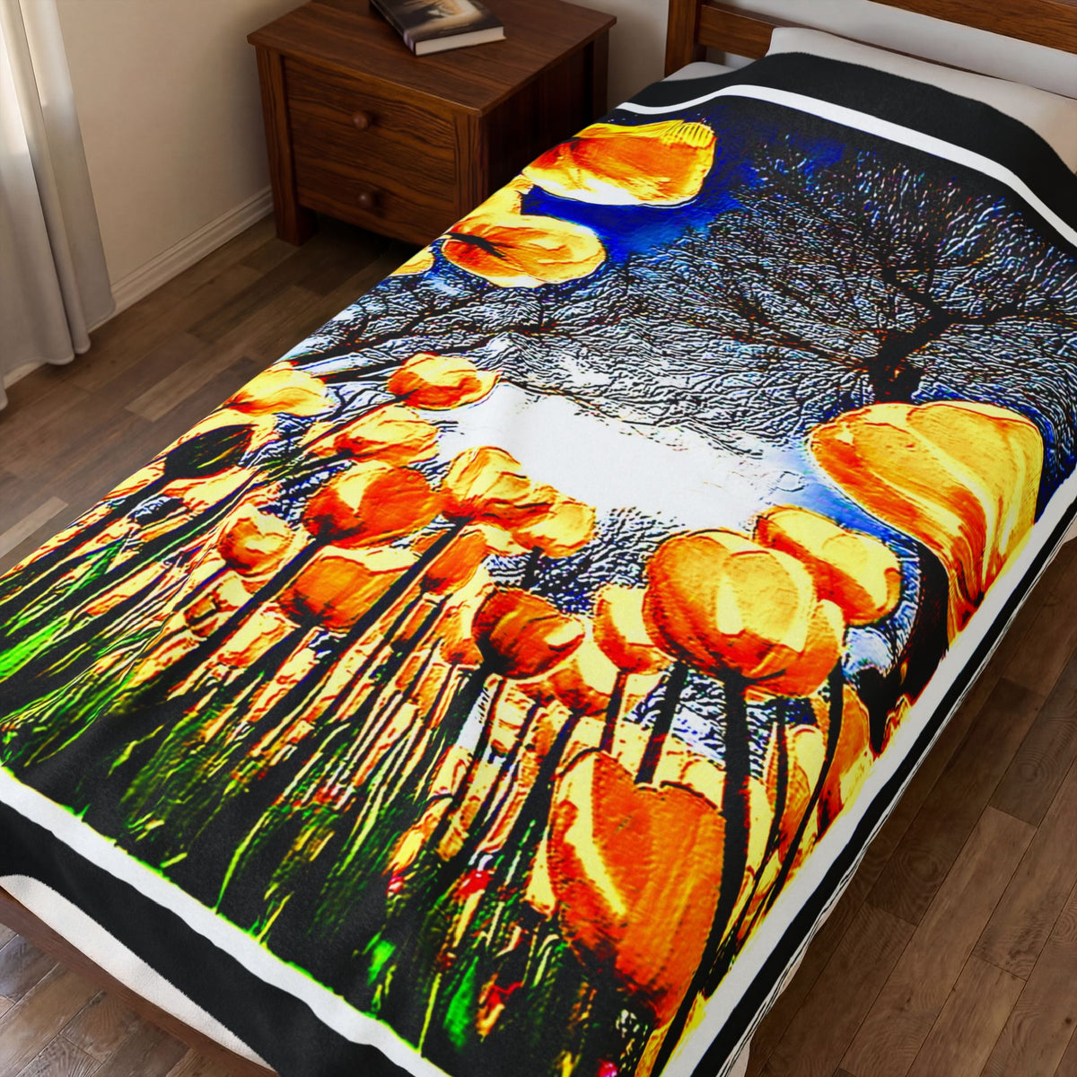 The Garden Beyond the Winter velveteen plush blanket draped over a twin bed, featuring golden yellow tulips against a bare winter tree.
