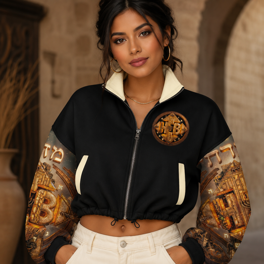 Woman wearing the Hebrew World Four Corners of the Faith black cropped fleece bomber jacket with graphic sleeves, front view.