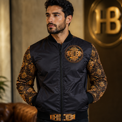 Front view of a man wearing the Hebrew World black quilted bomber jacket featuring ornate gold-patterned sleeves and a chest emblem.