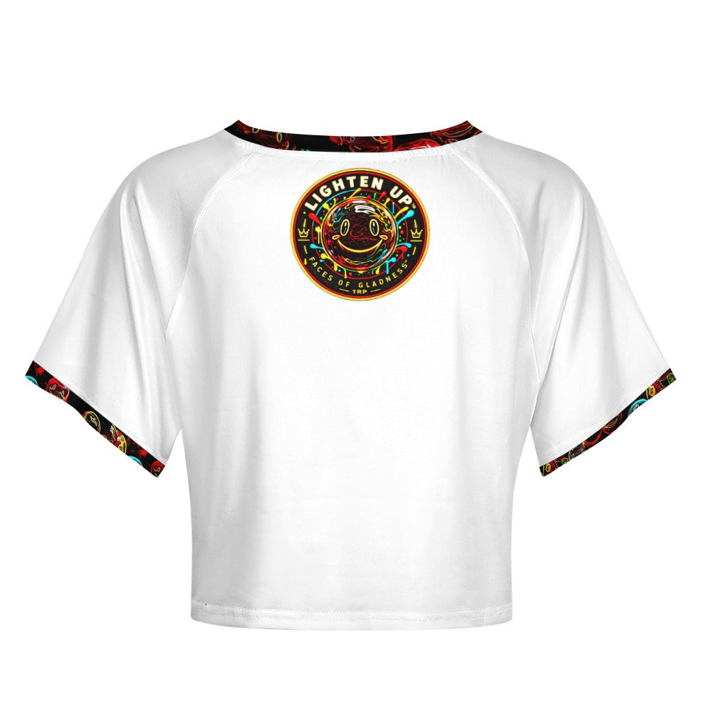 Back view of Lighten Up raglan crop top showing the circular Faces of Gladness smiley emblem on white fabric.