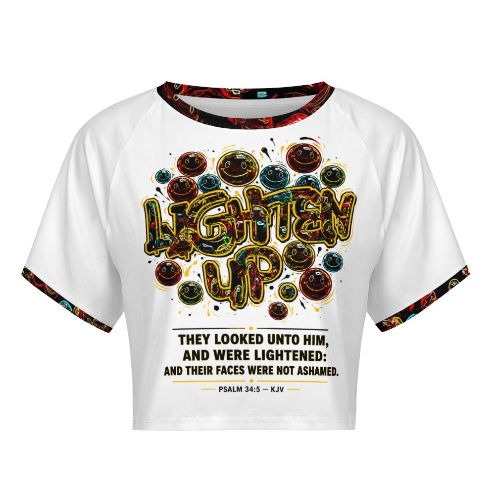 Front view of Lighten Up Psalm 34:5 raglan crop top featuring colorful smiley graphics and scripture text.
