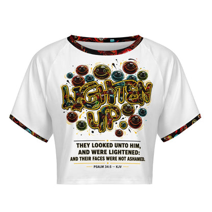 Front view of Lighten Up Psalm 34:5 raglan crop top featuring colorful smiley graphics and scripture text.