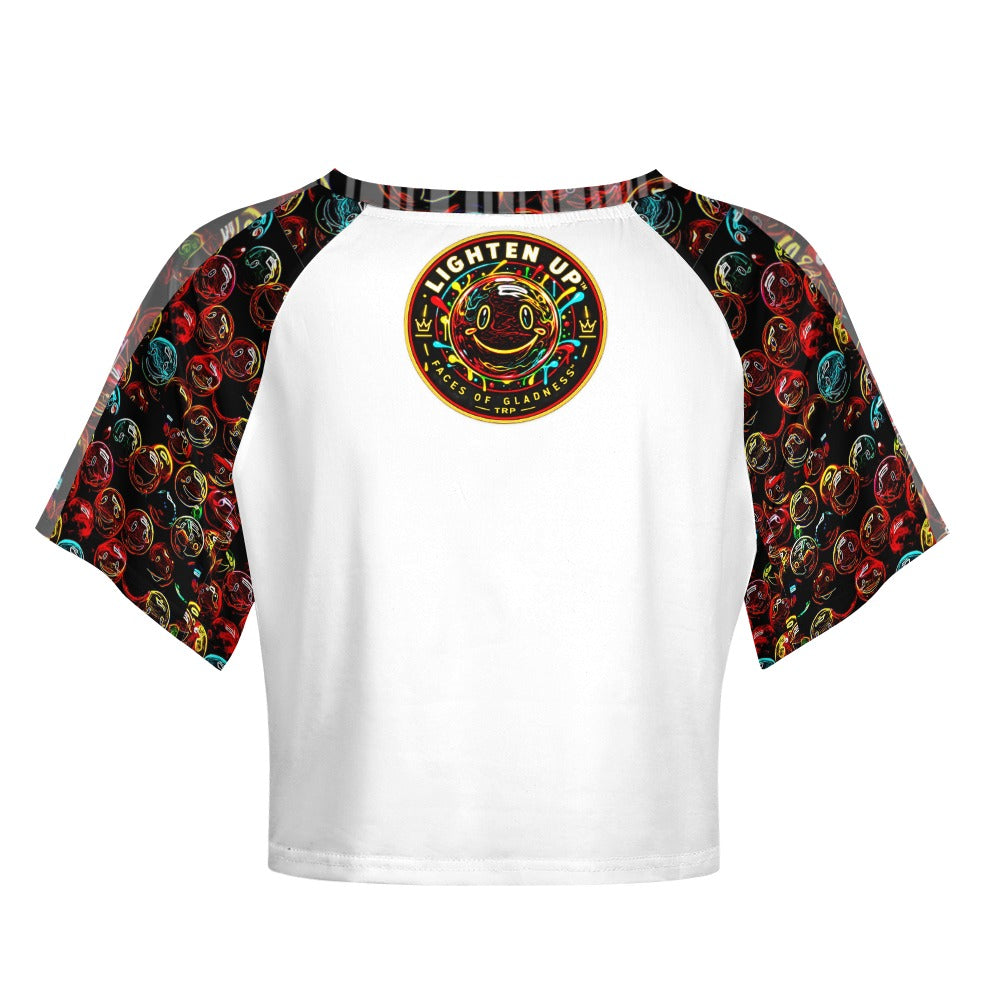 Back view of the Lighten Up raglan crop top with colorful smiley pattern sleeves and circular graphic crest