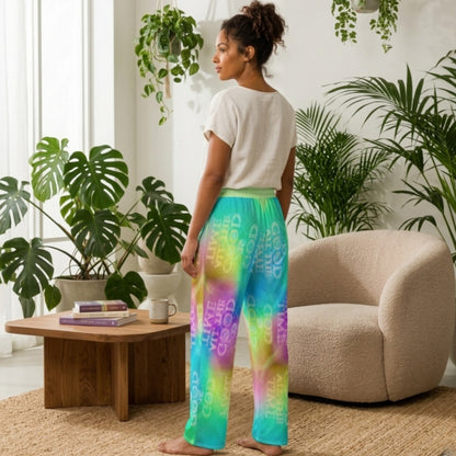 Woman wearing colorful pants in a room with plants and a coffee table.