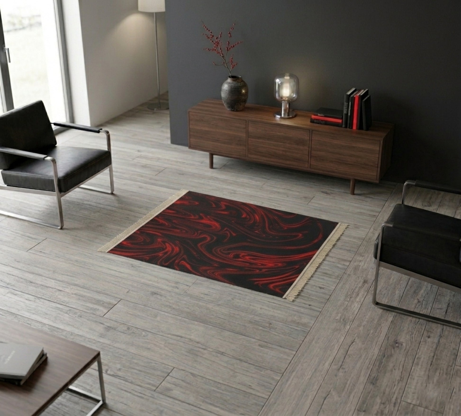 High-angle view of a minimalist living room featuring a small black and red swirl pattern rug on light wood floors near a wooden console table.