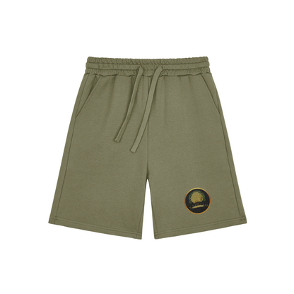 Flat lay of sage green Yahuah: Tree of Life sweat shorts featuring a golden tree emblem on the left leg against a white background.