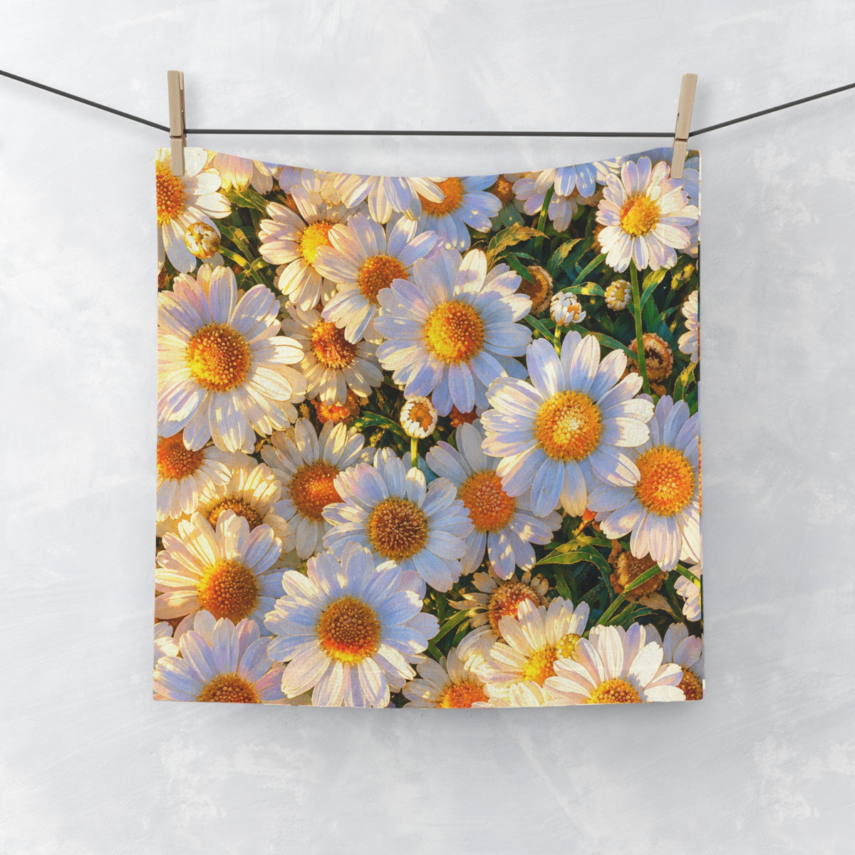 The Dawning Field hand and face towel featuring blooming white daisies hanging from a clothesline with wooden pins.