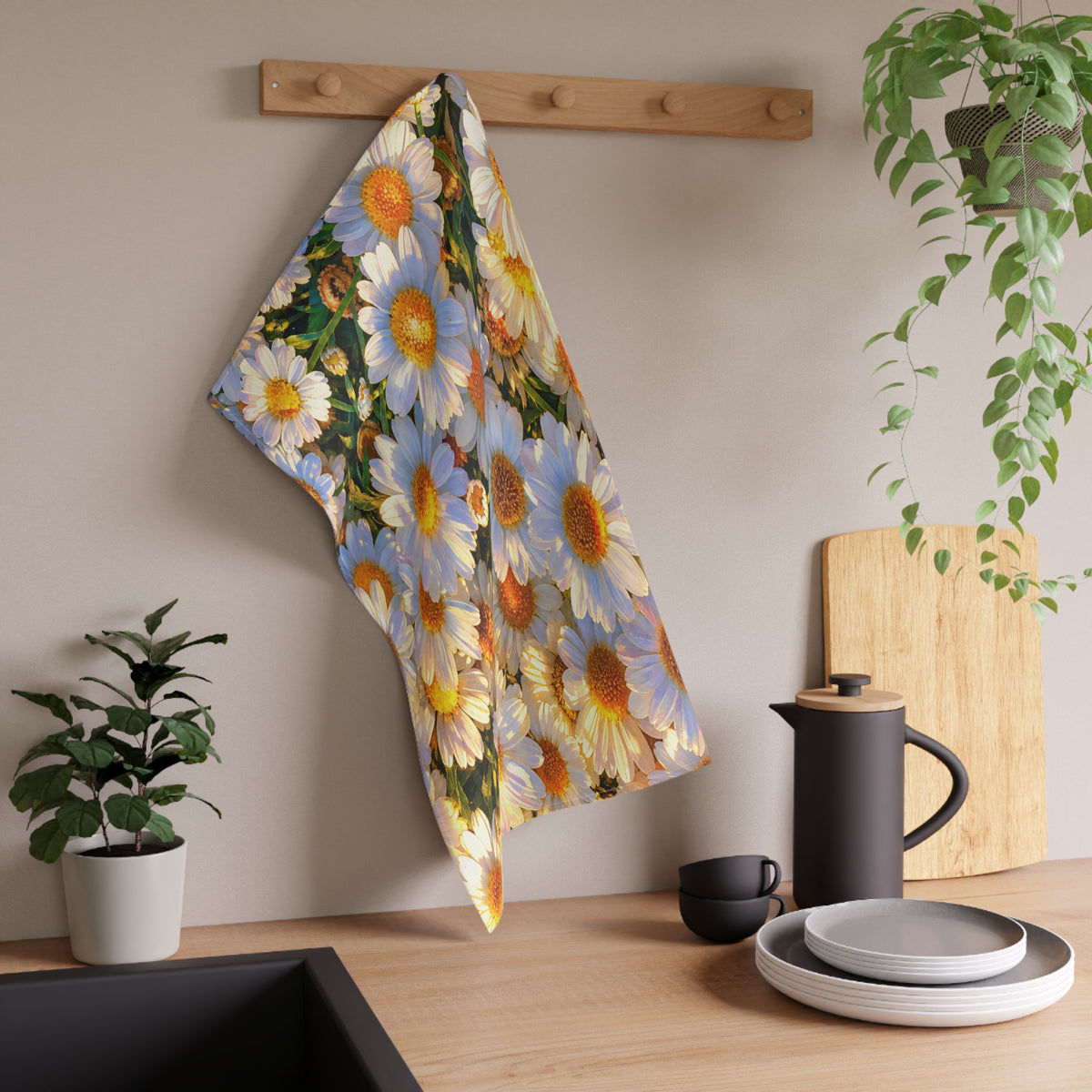 The Dawning Field kitchen hand towel hanging from a wooden peg rack over a kitchen counter with dishes and a black kettle.