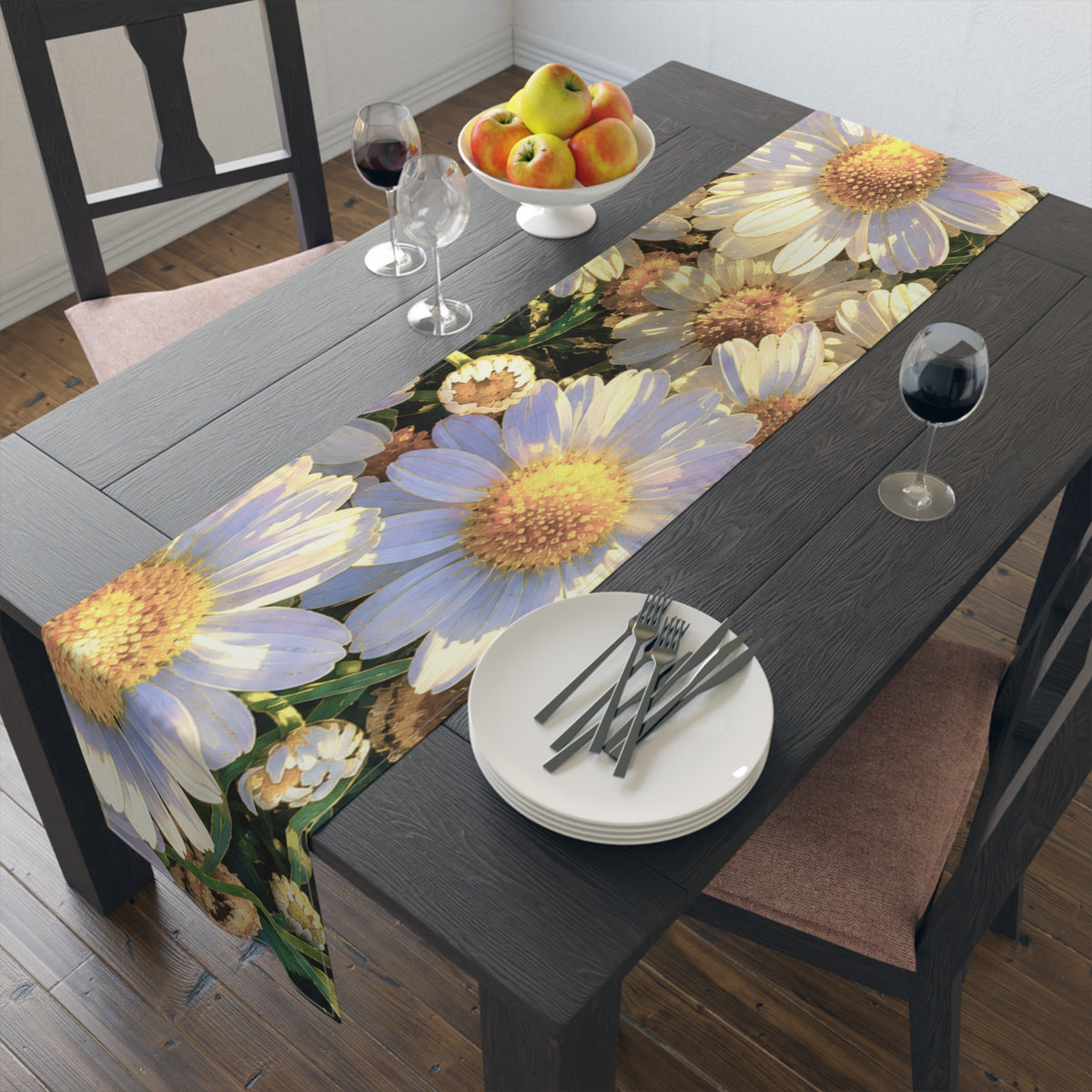 The Dawning Field floral table runner on a dark wood dining table set with white plates, flatware, wine glasses, and a bowl of apples.
