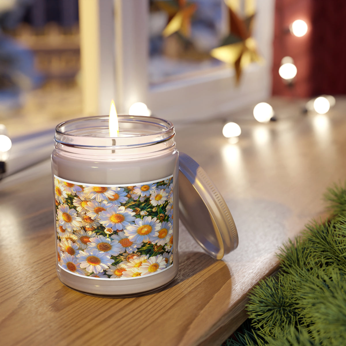The Dawning Field 9oz glass candle jar lit on a wooden windowsill framed by garland and warm string lighting.