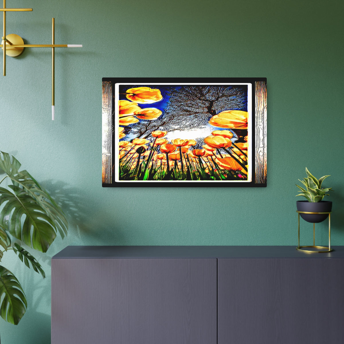 Metal wall art print with golden blooms mounted over a dark sideboard against a green wall.