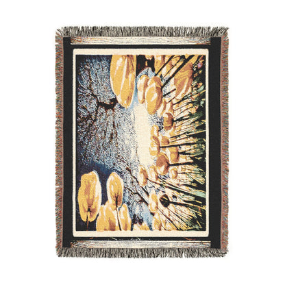 Full vertical flat lay view of The Garden Beyond the Winter woven throw blanket showing fringe edges and golden floral artwork.