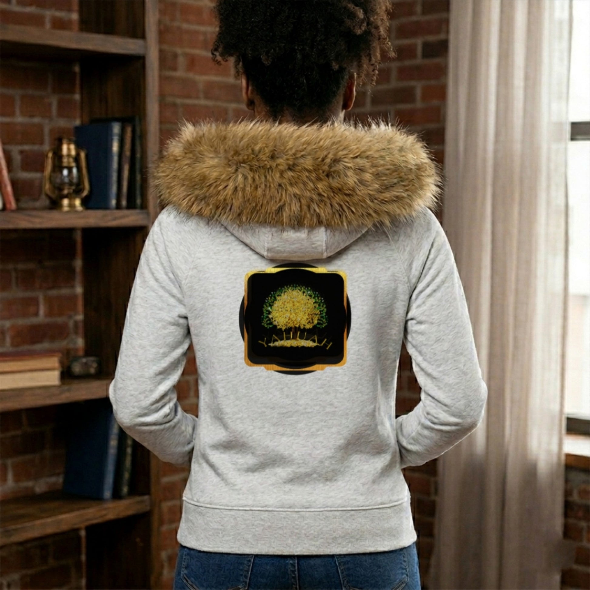 Back views of a woman in a grey faux fur trim hoodie, featuring the gold Yahuah Tree of Life emblem on the chest and a large graphic on the back.