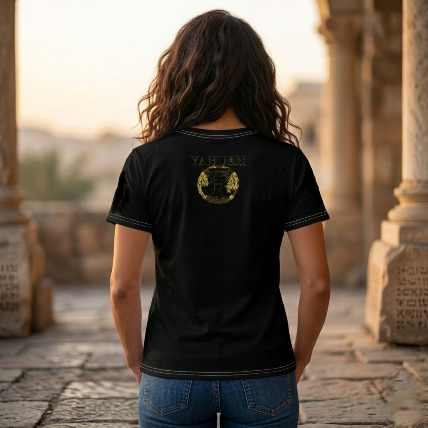 Back view of female model in Yahuah Yahusha black unisex tee showing the golden circular symbol below the neckline.