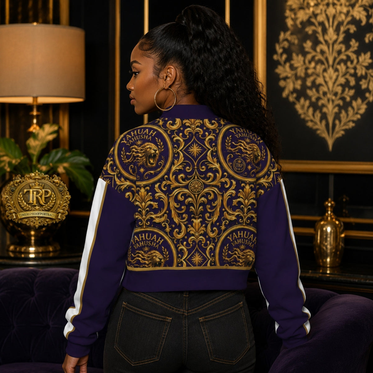 Back view shot showing the fit and gold ornate lion design of the Yahuah Yahusha cropped varsity jacket on a model.