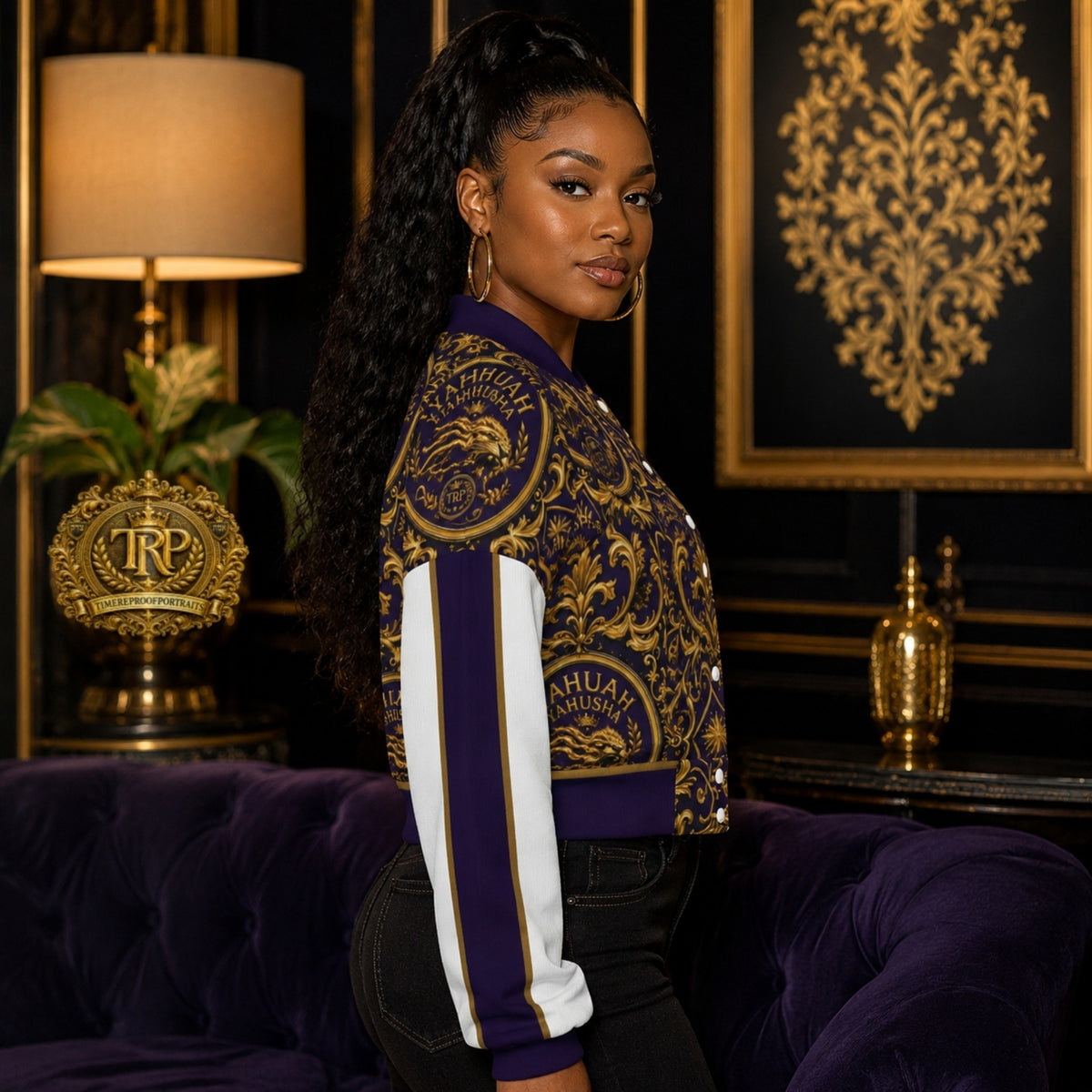 Right side view of a model wearing the purple and gold Yahuah Yahusha cropped drop-shoulder varsity jacket with striped sleeves.