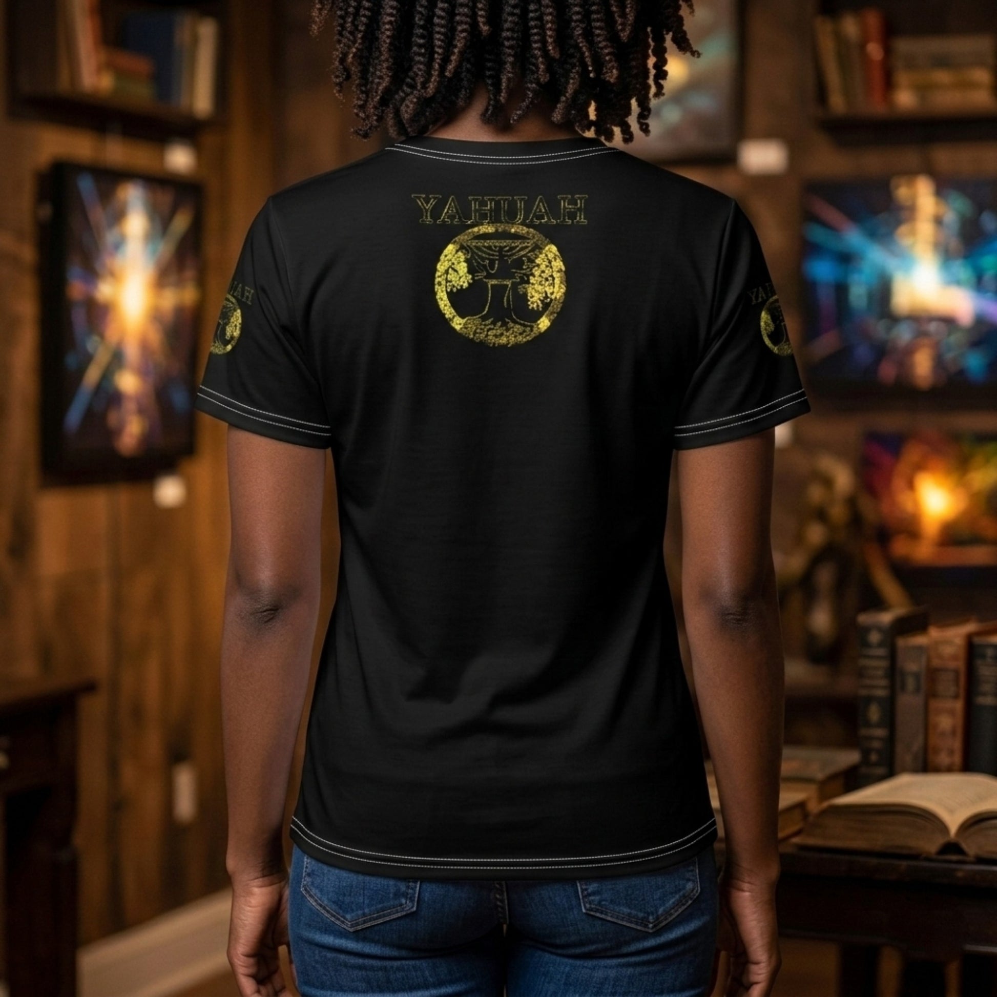 Rear view of a woman wearing the black Yahuah Yahusha t-shirt, showing a gold circular emblem below the collar.