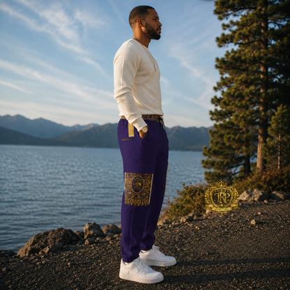 Right side profile view of a man styled in purple Yahuah Yahusha lantern cargo joggers with gold ornate pocket detailing.